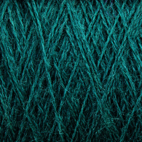 Close-up view of JaggerSpun Zephyr Wool-Silk 2/18 Yarn by Jagger Brothers, Inc., wound tightly in a crisscross pattern, showcasing the texture and intricate arrangement of the fibers. The image highlights the detailed and fibrous nature of the yarn, with a rich, emerald green color throughout.