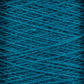 Close-up view of a large cone of JaggerSpun Zephyr Wool-Silk 2/18 Yarn by Jagger Brothers, Inc., showcasing its tightly wound dark teal threads in a criss-cross pattern. The texture appears slightly fuzzy, hinting at the softness of the material. This luxurious yarn boasts vibrant, rich colors that enhance its premium silk-like appeal.