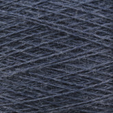 Close-up image of Jagger Brothers, Inc.'s luxurious JaggerSpun Zephyr Wool-Silk 2/18 Yarn in dark blue, with a slightly fuzzy texture, wound tightly in a pattern of overlapping diagonal lines. The yarn fibers and individual strands are visible, offering a detailed view of the material's texture and premium quality color.