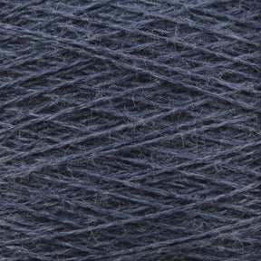 Close-up image of Jagger Brothers, Inc.'s luxurious JaggerSpun Zephyr Wool-Silk 2/18 Yarn in dark blue, with a slightly fuzzy texture, wound tightly in a pattern of overlapping diagonal lines. The yarn fibers and individual strands are visible, offering a detailed view of the material's texture and premium quality color.