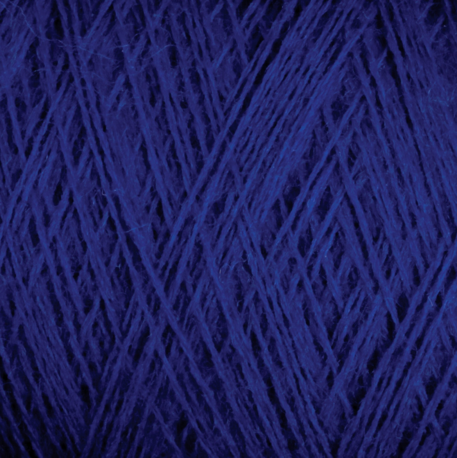 A close-up view of the dark blue, luxurious JaggerSpun Zephyr Wool-Silk 2/18 Yarn by Jagger Brothers, Inc., intricately wound into a large cone, displays the texture and strands in a web-like pattern. The fibers' rich color and tightly woven nature are clearly visible.