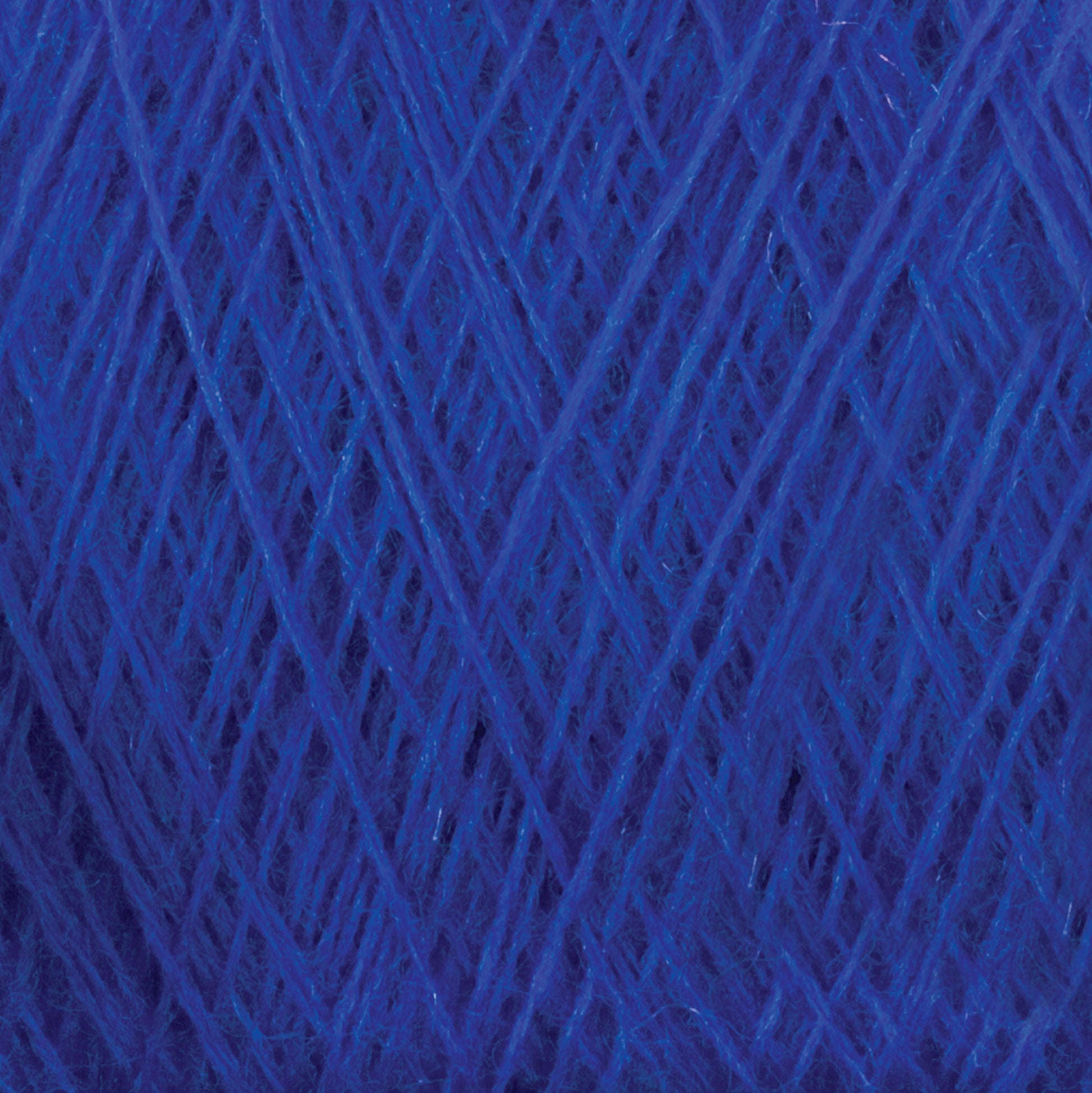 A close-up image of Jagger Brothers, Inc.'s JaggerSpun Zephyr Wool-Silk 2/18 Yarn in deep blue. The yarn, wound tightly on a large cone, crisscrosses in multiple overlapping layers, creating a textured and intricate pattern. The vibrant blue color stands out prominently, showcasing its premium silk quality.