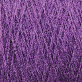 Close-up image of JaggerSpun Zephyr Wool-Silk 2/18 Yarn | Large Cone by Jagger Brothers, Inc. The fibers are textured and intertwined, creating a dense and soft appearance. The vibrant purple color adds a rich and cozy feel to the luxurious material.