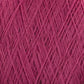 Close-up of a ball of dark pink luxurious JaggerSpun Zephyr Wool-Silk 2/18 Yarn by Jagger Brothers, Inc., tightly wound with crisscrossing strands creating a textured pattern. The fibers appear soft and slightly fuzzy, providing a detailed view of the yarn's woven structure.