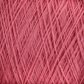 A close-up view of JaggerSpun Zephyr Wool-Silk 2/18 Yarn | Mini-cone from Jagger Brothers, Inc. reveals pink strands tightly wound together, forming a textured pattern of intersecting lines and layers. This luxurious yarn showcases a soft, slightly fuzzy appearance.