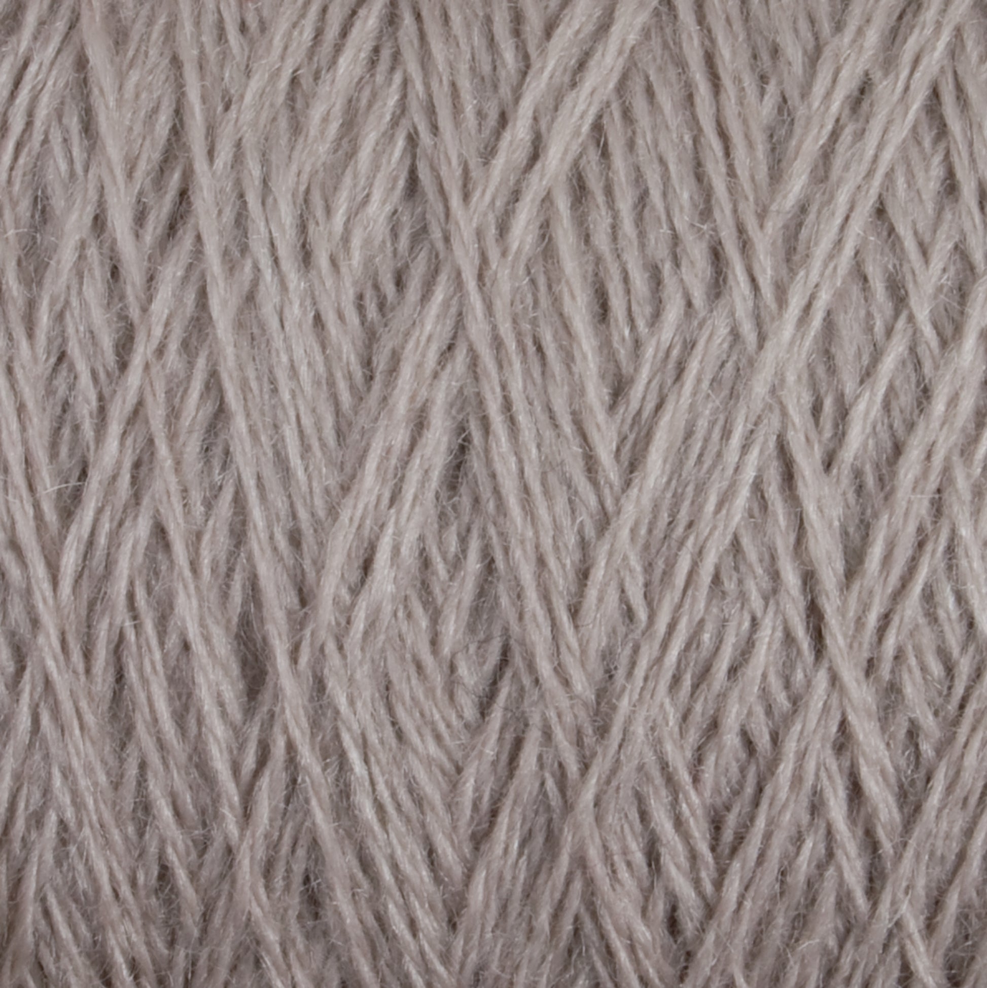 Close-up view of a tightly wound ball of JaggerSpun Zephyr Wool-Silk 2/18 Yarn in light grey. The fibers of this luxurious yarn from Jagger Brothers, Inc. are neatly arranged in a crisscross pattern, showcasing the texture and thickness typically found in premium silk blends.