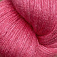 Close-up image of a skein of JaggerSpun Zephyr Wool-Silk 2/18 Yarn in bright pink, featuring a textured and slightly shiny surface that hints at the luxurious blend of wool and silk. The yarn is tightly wound on a large cone from Jagger Brothers, Inc., displaying its rich, vibrant color and soft, delicate fibers.