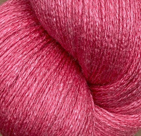 Close-up image of a skein of JaggerSpun Zephyr Wool-Silk 2/18 Yarn in bright pink, featuring a textured and slightly shiny surface that hints at the luxurious blend of wool and silk. The yarn is tightly wound on a large cone from Jagger Brothers, Inc., displaying its rich, vibrant color and soft, delicate fibers.