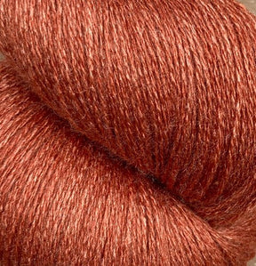 Close-up image of a skein of JaggerSpun Zephyr Wool-Silk 2/18 Yarn from Jagger Brothers, Inc. in a rich, reddish-brown color with a slightly shiny texture. The strands are tightly wound, highlighting the luxurious yarn's smooth and soft appearance.