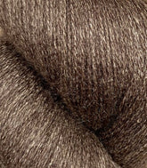 Close-up image of Jagger Brothers, Inc.'s JaggerSpun Zephyr Wool-Silk 2/18 Yarn | Large Cone. The luxurious yarn has a slightly shiny appearance and a dense interwoven pattern, showcasing its soft and fibrous nature.