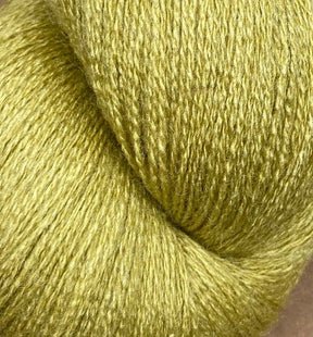 A close-up image of a skein of JaggerSpun Zephyr Wool-Silk 2/18 Yarn by Jagger Brothers, Inc. The blend of Australian merino wool and premium silk gives it a soft, textured feel with a slightly shiny appearance. The light green hue is vibrant and consistent throughout the skein.