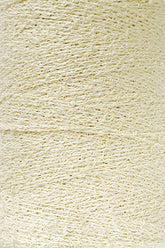 Close-up view of a large spool of off-white Maurice Brassard Cotton Bouclé Yarn | Mini-Cone. The yarn is wound tightly around the spool in numerous layers, showcasing a slightly uneven and intricate pattern of fibers. The texture appears soft and fibrous, perfect for knitting or weaving projects.