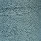 Close-up of a textured grey surface showing numerous intertwined, wave-like patterns. The material appears to be rough and fibrous, reminiscent of Maurice Brassard's intricate Cotton Bouclé Yarn, suggesting it could be a detailed portion of fabric or another textured synthetic material.