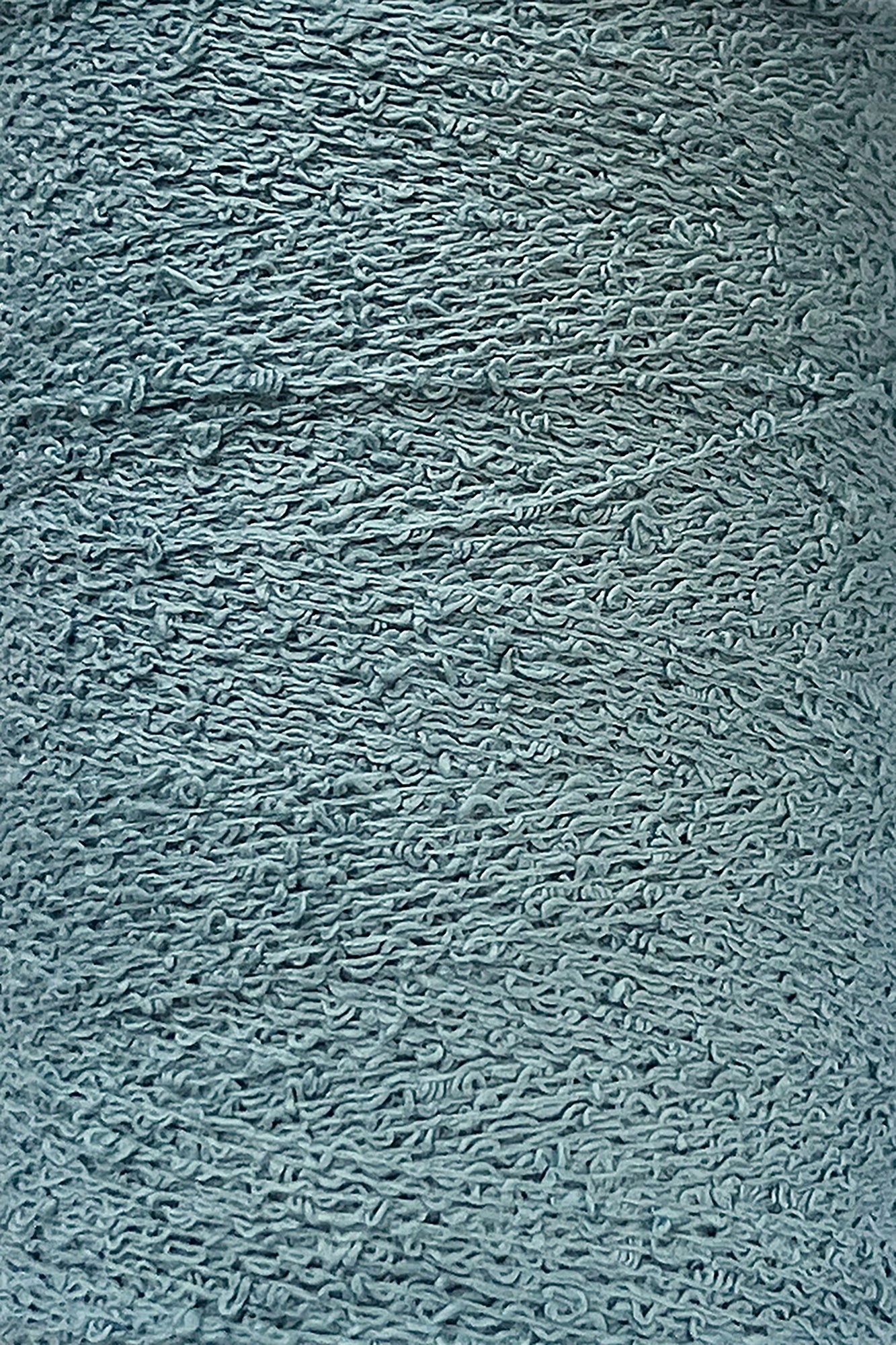 Close-up of a textured grey surface showing numerous intertwined, wave-like patterns. The material appears to be rough and fibrous, reminiscent of Maurice Brassard's intricate Cotton Bouclé Yarn, suggesting it could be a detailed portion of fabric or another textured synthetic material.