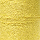 Close-up shot of a spool of vibrant yellow Cotton Bouclé Yarn | Tube by Maurice Brassard. The texture is clearly visible, showcasing its tightly wound, slightly curly threads.