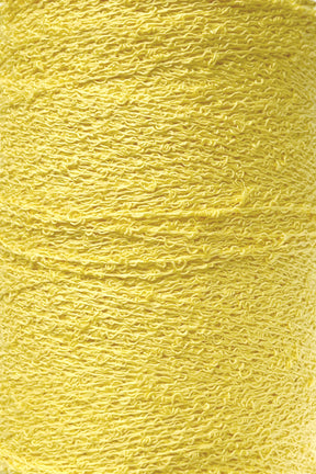 Close-up shot of a spool of vibrant yellow Cotton Bouclé Yarn | Tube by Maurice Brassard. The texture is clearly visible, showcasing its tightly wound, slightly curly threads.