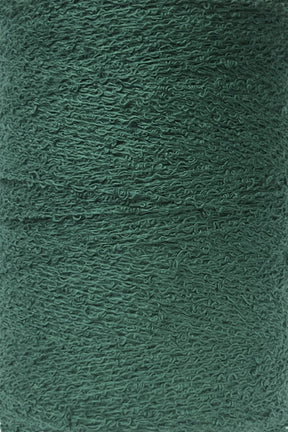 A close-up view of Maurice Brassard's Cotton Bouclé Yarn | Tube in a rich, deep green shade. This yarn features a textured, slightly fuzzy surface with visible twists and fibers.