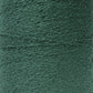 A close-up image of a spool of Maurice Brassard Cotton Bouclé Yarn | Mini-Cone in forest green. The texture of the 100% cotton yarn is visible, showcasing its tightly woven strands. The overall appearance is uniform in color and texture, with slight variations on the surface due to the fibrous material.