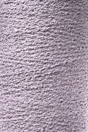 Close-up image of a spool of Maurice Brassard's Cotton Bouclé Yarn | Tube in light gray. The texture appears soft and slightly uneven, with visible loops and strands, creating a detailed pattern throughout the spool's surface.