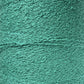 Close-up image of a spool of Maurice Brassard's Cotton Bouclé Yarn | Tube. The surface appears wavy and rough, with intricate loops and twists throughout, creating a detailed, tactile pattern. The color is a solid, vibrant green. Ideal for weaving projects by artisans who appreciate high-quality cotton materials.