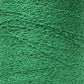 Close-up image of a spool of bright green Maurice Brassard Cotton Bouclé Yarn. The texture of the thread is visible, with intricate patterns and slight irregularities in the strands, creating a detailed and tactile effect. The color is vibrant and consistent throughout the spool.