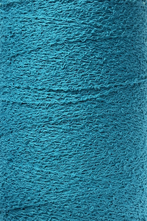 Close-up of a turquoise textured surface showing intricate patterns of thread or fibers, likely from Maurice Brassard's Cotton Bouclé Yarn. The surface exhibits a tightly woven, slightly rough texture with subtle variations in color due to the weave, reminiscent of premium Cotton Bouclé.