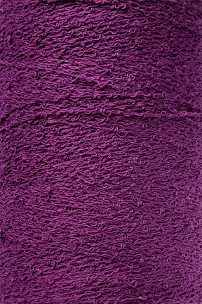 A close-up image of tightly-wound deep purple yarn. The texture and individual strands are visible, showcasing the intricate pattern reminiscent of Maurice Brassard's Cotton Bouclé Yarn | Tube.