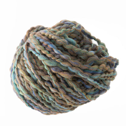 A close-up photo of Bear Creek Yarn by Kraemer, showcasing its thick and plush texture with twisted strands. The super bulky yarn features rich hues of blue, green, and brown against a white background, making it perfect for handknits that offer immediate gratification.