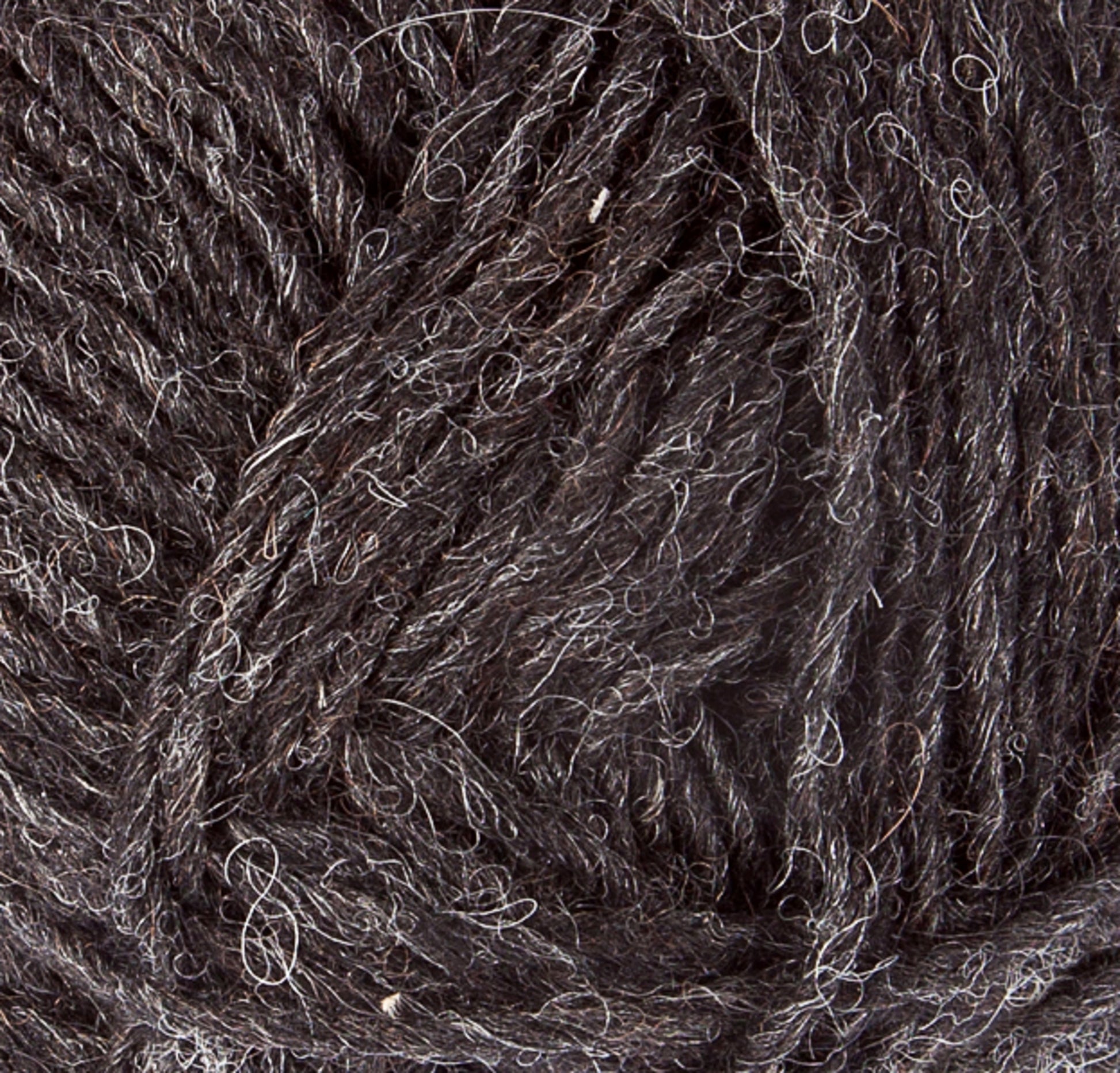 A close-up image of dark, woolen yarn, revealing the textured fibers and strands of Léttlopi (Lite Lopi) Icelandic Wool Yarn from Berroco, Inc. The yarn appears thick and slightly coarse, with a mix of dark gray and lighter gray fibers interwoven, giving it a rustic and natural appearance—perfect for creating durable garments or intricate colorwork knitting projects.