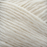 Close-up image of a section of Léttlopi (Lite Lopi) Icelandic Wool Yarn by Berroco, Inc. The soft fibers are loosely twisted and have a slightly fluffy, textured appearance. This off-white Icelandic wool showcases its natural, creamy color and smooth, yet fibrous surface—an ideal choice for durable garments or intricate colorwork knitting projects.