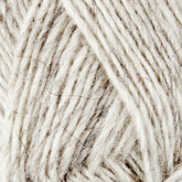 Close-up image of a ball of Léttlopi (Lite Lopi) Icelandic Wool Yarn by Berroco, Inc., showcasing its texture and fibers. The yarn is light grey with threads of darker grey interwoven, creating a soft, fuzzy appearance. Perfect for colorwork and knitting projects, the image highlights the detail and intricacy of the yarn's strands.