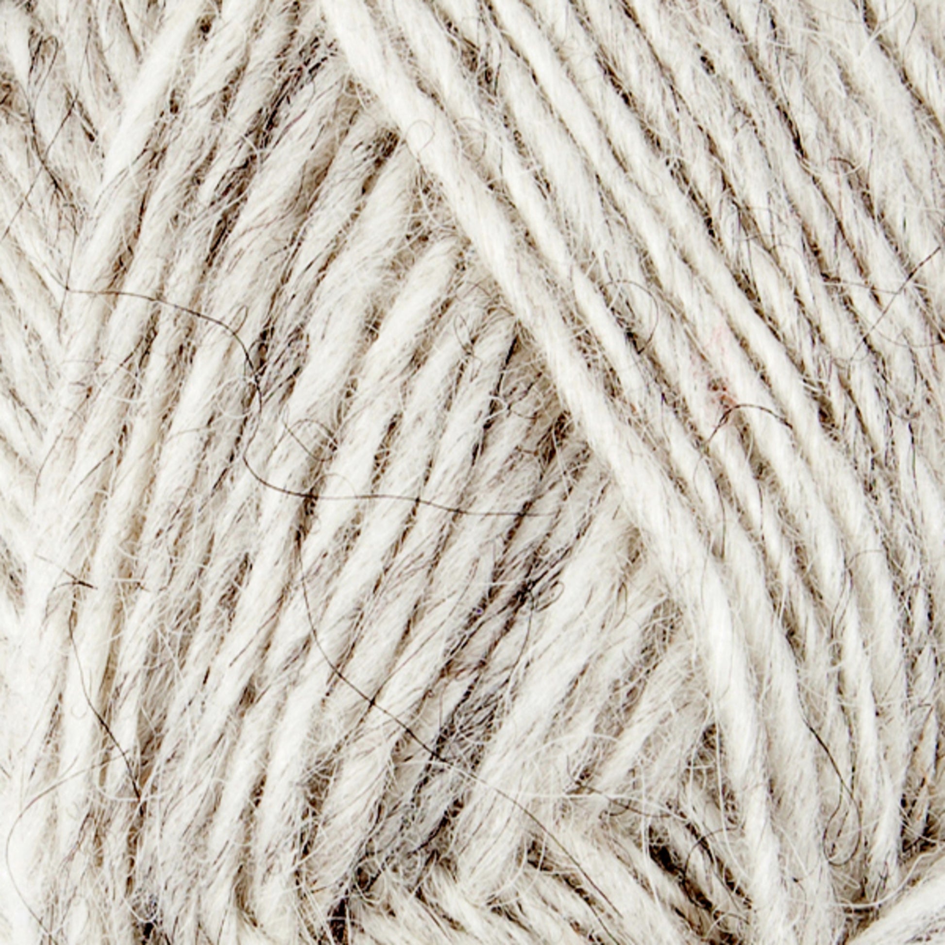 Close-up image of a ball of Léttlopi (Lite Lopi) Icelandic Wool Yarn by Berroco, Inc., showcasing its texture and fibers. The yarn is light grey with threads of darker grey interwoven, creating a soft, fuzzy appearance. Perfect for colorwork and knitting projects, the image highlights the detail and intricacy of the yarn's strands.