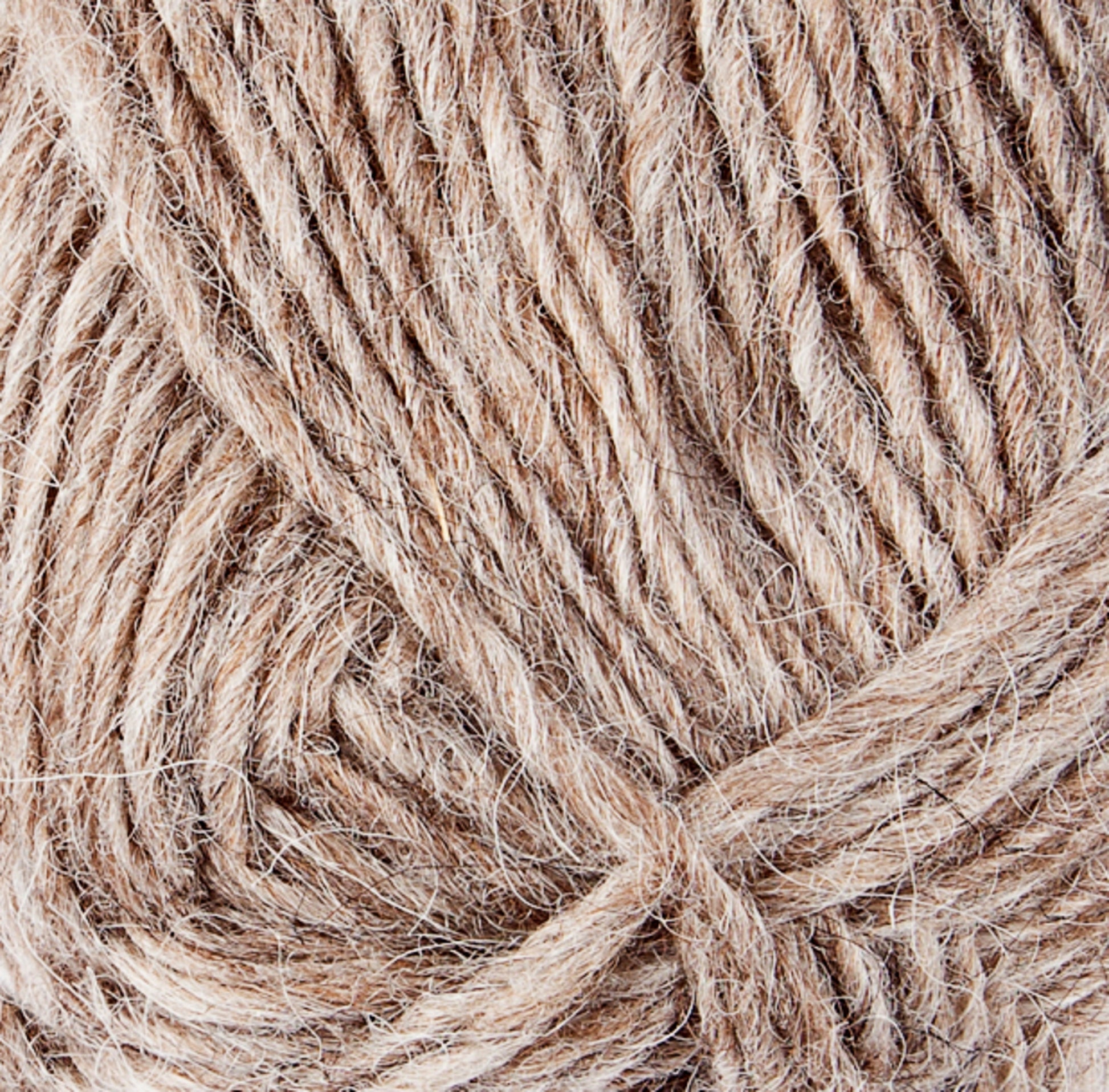 Close-up image of a ball of light brown Léttlopi (Lite Lopi) Icelandic Wool Yarn by Berroco, Inc., displaying its soft and textured fibers twisted together, perfect for colorwork knitting.