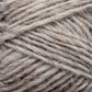 Close-up view of a skein of natural-colored, light brown Léttlopi (Lite Lopi) Icelandic Wool Yarn by Berroco, Inc., showcasing the texture and twist of the fibers. Ideal for colorwork knitting, the yarn appears soft and slightly fuzzy, perfect for creating durable garments.