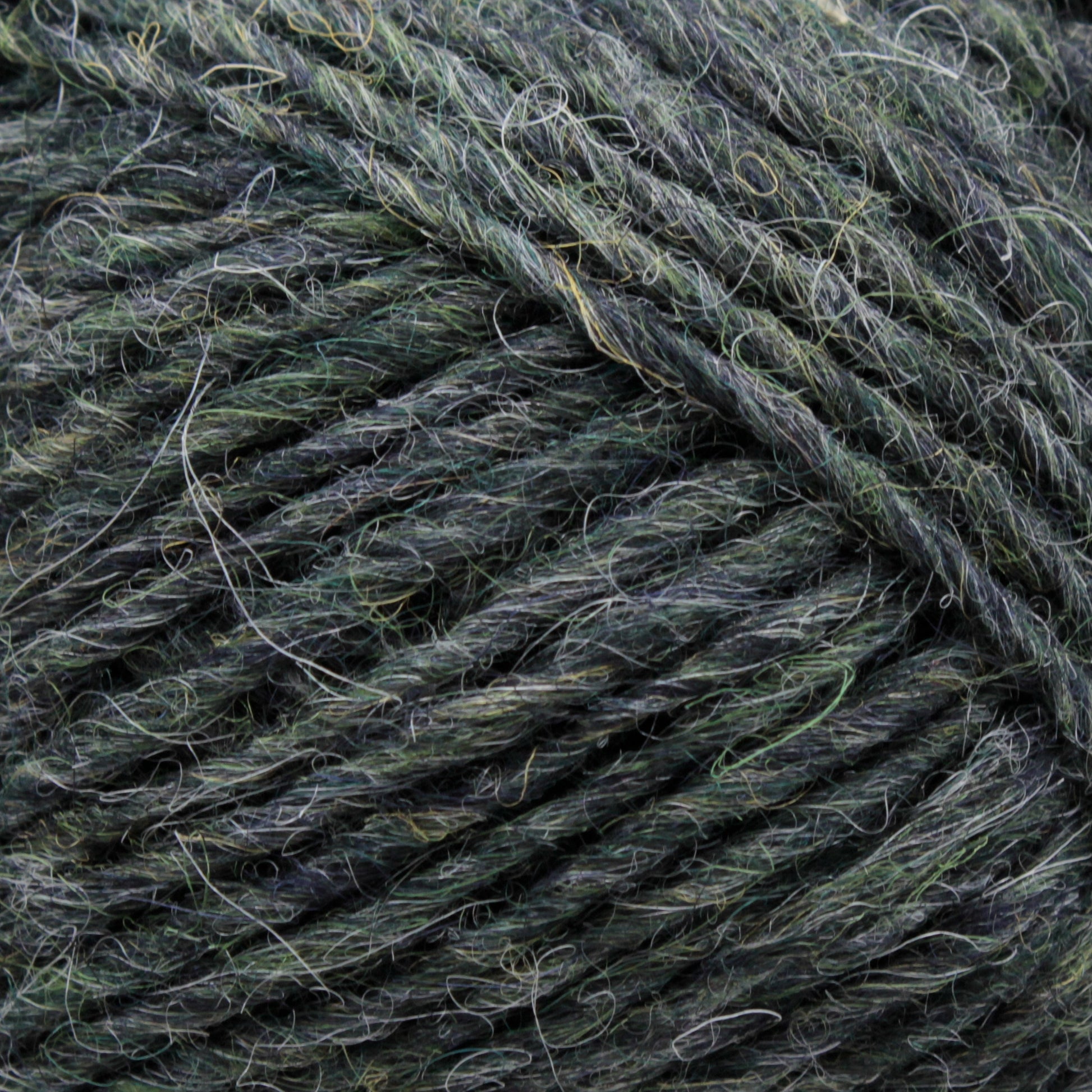 Close-up image of dark green and gray multi-tonal Léttlopi (Lite Lopi) Icelandic Wool Yarn by Berroco, Inc., showcasing the texture and fibers. The yarn appears thick and slightly fuzzy with intertwined strands, perfect for durable garments or intricate colorwork knitting projects.