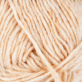 Close-up of a ball of Léttlopi (Lite Lopi) Icelandic Wool Yarn from Berroco, Inc., showcasing its textured and slightly fuzzy cream-colored fibers. The loosely wound strands create a soft and inviting appearance, ideal for colorwork knitting or crochet projects aimed at crafting durable garments.