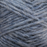 Close-up image of a ball of Berroco, Inc. Léttlopi (Lite Lopi) Icelandic Wool Yarn in blue. The fibers are thick and slightly tangled, with visible individual strands and a soft texture. The hue is a muted blue with subtle variations in shade, ideal for colorwork knitting or crafting durable garments.