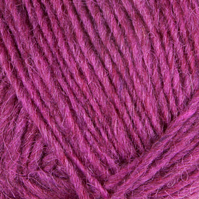 Close-up image of Berroco, Inc.'s Léttlopi (Lite Lopi) Icelandic Wool Yarn in magenta. The yarn appears soft with visible fibers and strands woven together. The texture is slightly fuzzy, suggesting that this Icelandic wool material—perfect for colorwork knitting in durable garments—is well-suited for your next project.