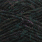 Close-up of a ball of dark, multicolored Léttlopi (Lite Lopi) Icelandic Wool Yarn from Berroco, Inc. with strands of green, blue, and purple interwoven. The texture is fuzzy and slightly irregular, making it perfect for creating durable garments that highlight the individual threads and fibers. Ideal for intricate colorwork knitting projects.