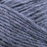 Close-up image of a bundle of soft, light gray Léttlopi (Lite Lopi) Icelandic wool yarn by Berroco, Inc. showing the texture and fibers. The yarn is tightly wound, with visible strands running parallel and some fine hair-like fibers sticking out, highlighting its fluffy and cozy appearance—perfect for durable garments or colorwork knitting.