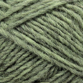 Close-up of several strands of the light green Léttlopi (Lite Lopi) Icelandic Wool Yarn by Berroco, Inc., intricately intertwined and showcasing the texture and fibers perfect for colorwork knitting.