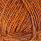 Close-up image of a ball of thick, textured yarn in a rich, warm orange color. The Léttlopi (Lite Lopi) Icelandic Wool Yarn by Berroco, Inc. is neatly wound, displaying the intricate fibers and texture, perfect for durable garments or colorwork knitting.