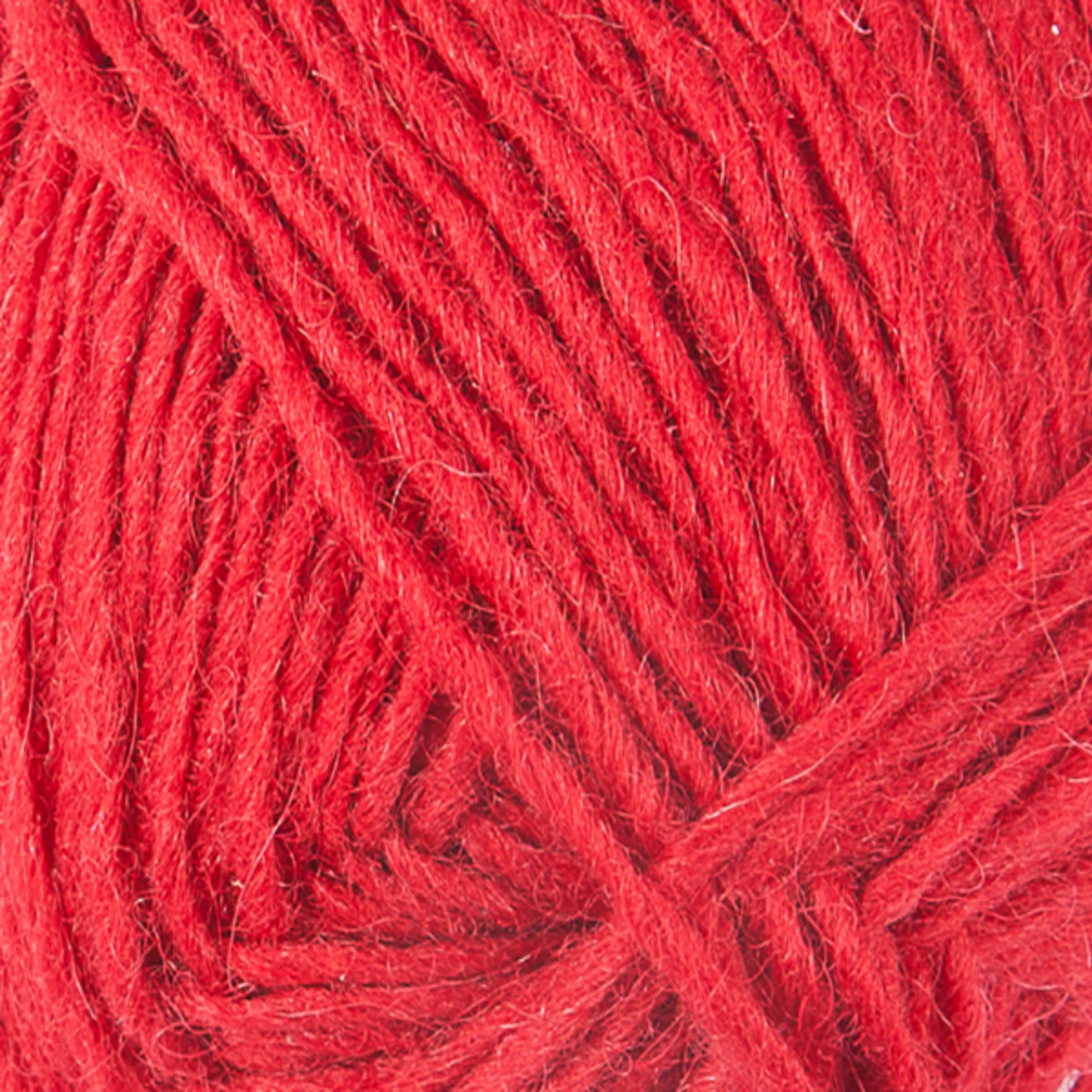 A close-up image of Léttlopi (Lite Lopi) Icelandic Wool Yarn by Berroco, Inc., showcasing the detailed texture and fibers of the yarn strands. The wool is tightly wound, creating a neat and orderly pattern. The vibrant red color is consistent throughout the image, making it perfect for durable garments or intricate colorwork knitting projects.