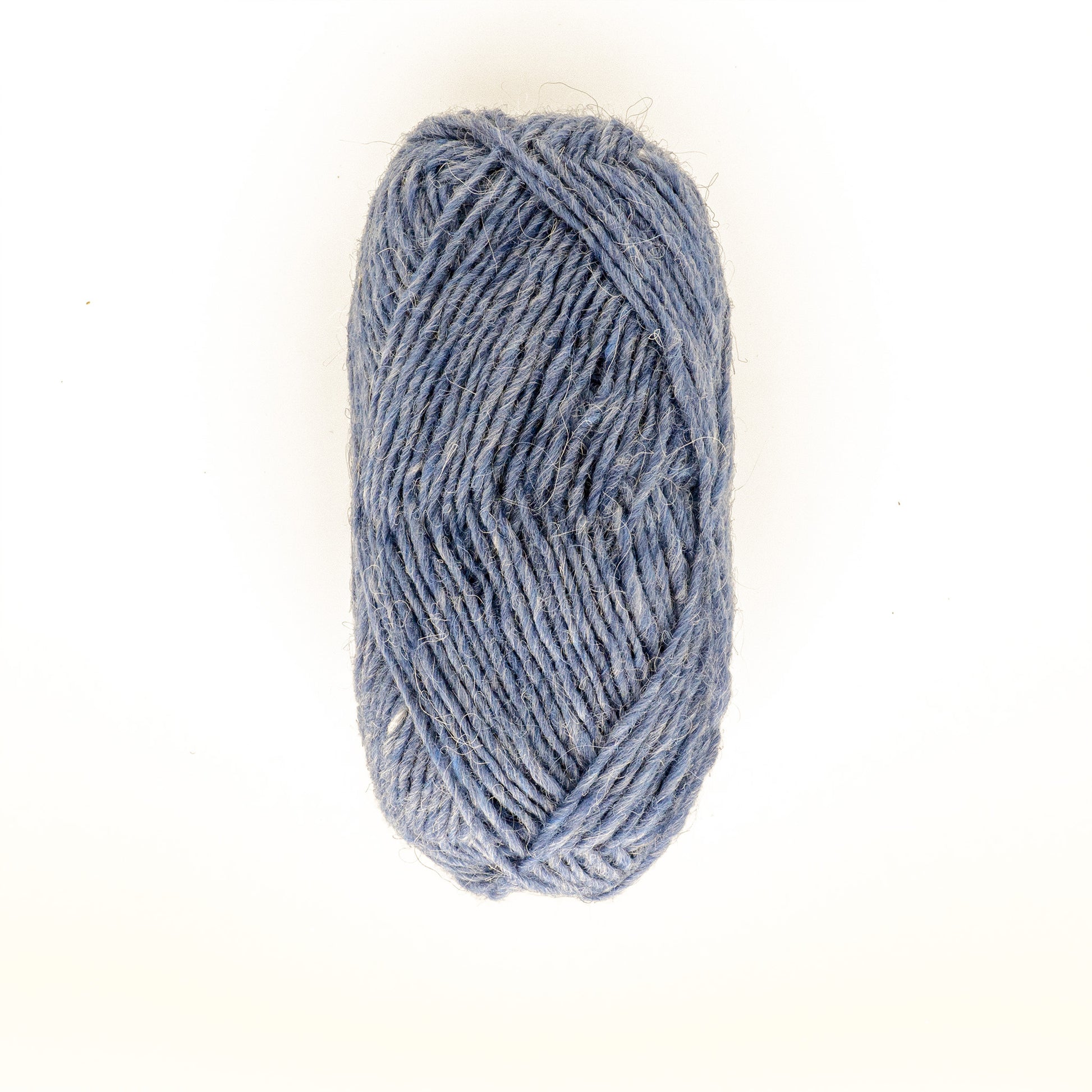 A single skein of Berroco, Inc.'s Léttlopi (Lite Lopi) Icelandic Wool Yarn in light blue is positioned against a plain white background. The neatly wound yarn has a slightly textured appearance, making it perfect for colorwork knitting and crafting durable garments.