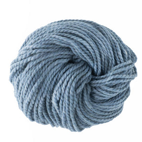 A tightly coiled ball of ultra-soft, thick, light blue Baby Alpaca Grande yarn by Plymouth Yarn Co. is centrally positioned against a plain white background. Its plush texture makes it perfect for knitting or crocheting.