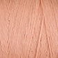 Close-up image of a soft, pastel peach-colored Cotton Carpet Warp 8/4 by Great Northern Weaving. The fibers are tightly twisted, creating a smooth, consistent texture perfect for crafting delicate cotton warp coverlets. The color appears uniform throughout the yarn, and the surface shows fine details of the strands.