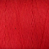 Close-up of Great Northern Weaving's Cotton Carpet Warp 8/4 in red, revealing the detailed texture and individual strands tightly wound together. The yarn appears to be soft and evenly colored throughout, ideal for knitting or crocheting projects like rag rugs or coverlets.