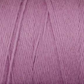 Close-up of a ball of Cotton Carpet Warp 8/4 from Great Northern Weaving in a soft pastel purple color. The cotton warp yarn fibers appear thick and smooth, with visible texture and strands neatly wound together. The color is consistent throughout, creating a gentle and cozy feel, reminiscent of handmade coverlets.