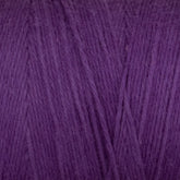 Close-up of Great Northern Weaving's Cotton Carpet Warp 8/4, showcasing the texture and fine fibers woven together to form a dense, soft material. The warp yarn displays a rich, deep purple color with subtle variations in shade, highlighting the natural twists and patterns formed in the thread.