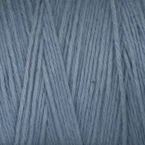 Close-up of Great Northern Weaving's Cotton Carpet Warp 8/4 in light blue, revealing tightly wound fibers arranged in a neat and uniform pattern. The texture appears soft and slightly fuzzy, resembling the delicate weave characteristic of high-quality cotton warp yarn. Individual strands are visible, showcasing its exceptional craftsmanship.